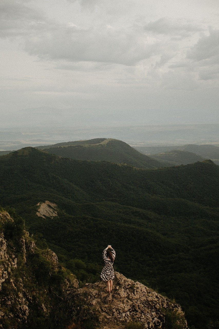 landscape, woman, nature, georgia, mountains, woman in pattern, dress, clouds, sky, view, summit, georgian, rock formation, in the mountains, solitary, peaceful, travel, hiking, remote, person